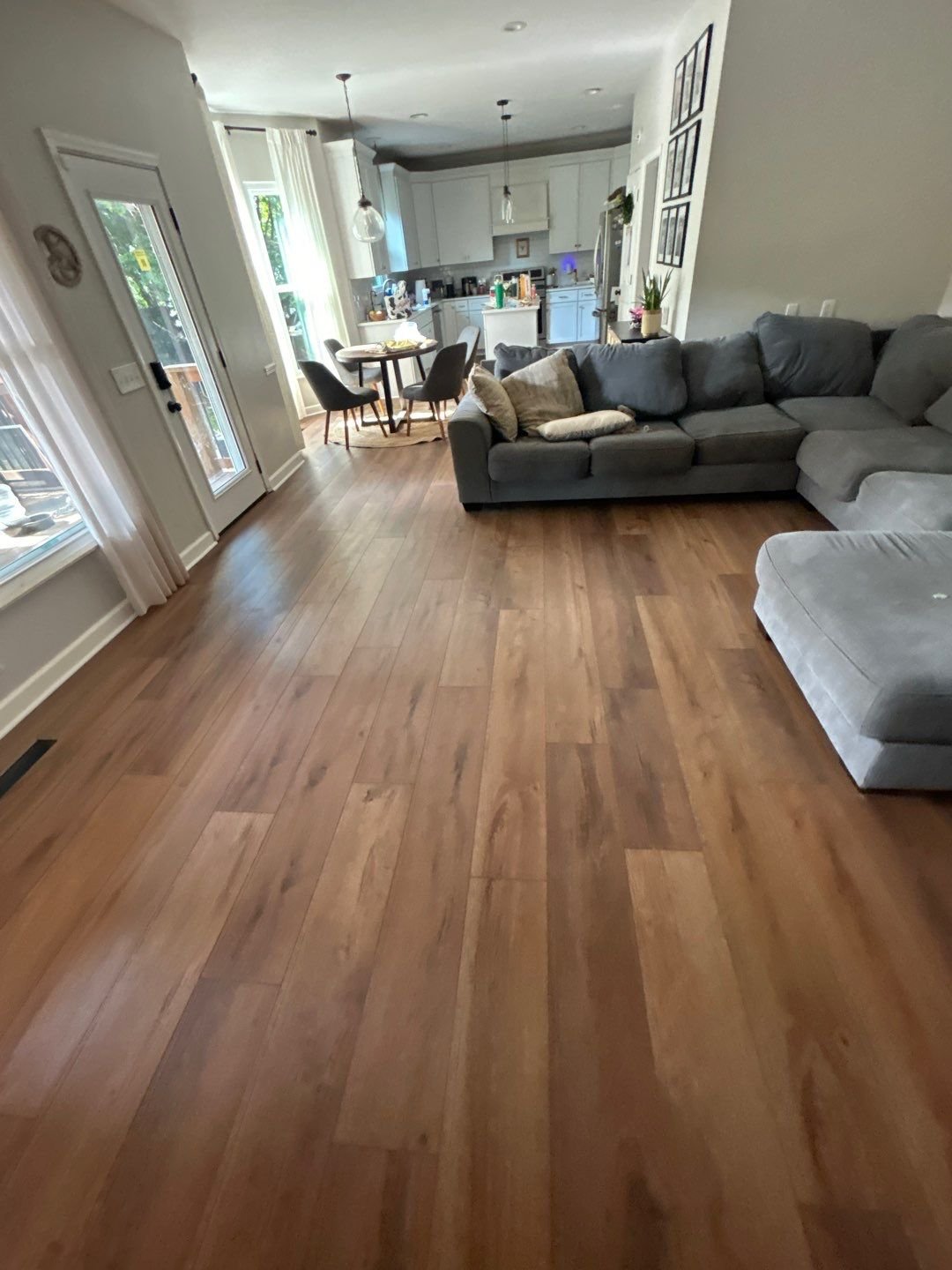 From torn-up subfloor to showroom-worthy rooms 🏡✨ We demoed the old nail-down hardwood, prepped the subfloor, and installed click-lock LVP throughout the entry, living room, kitchen, dining room, and more &mdash; then finished the staircase with new site-finished treads and a traditional Red Oak railing. Every plank laid tight, every tread dialed in. Ready to transform your floors? Drop us a message!