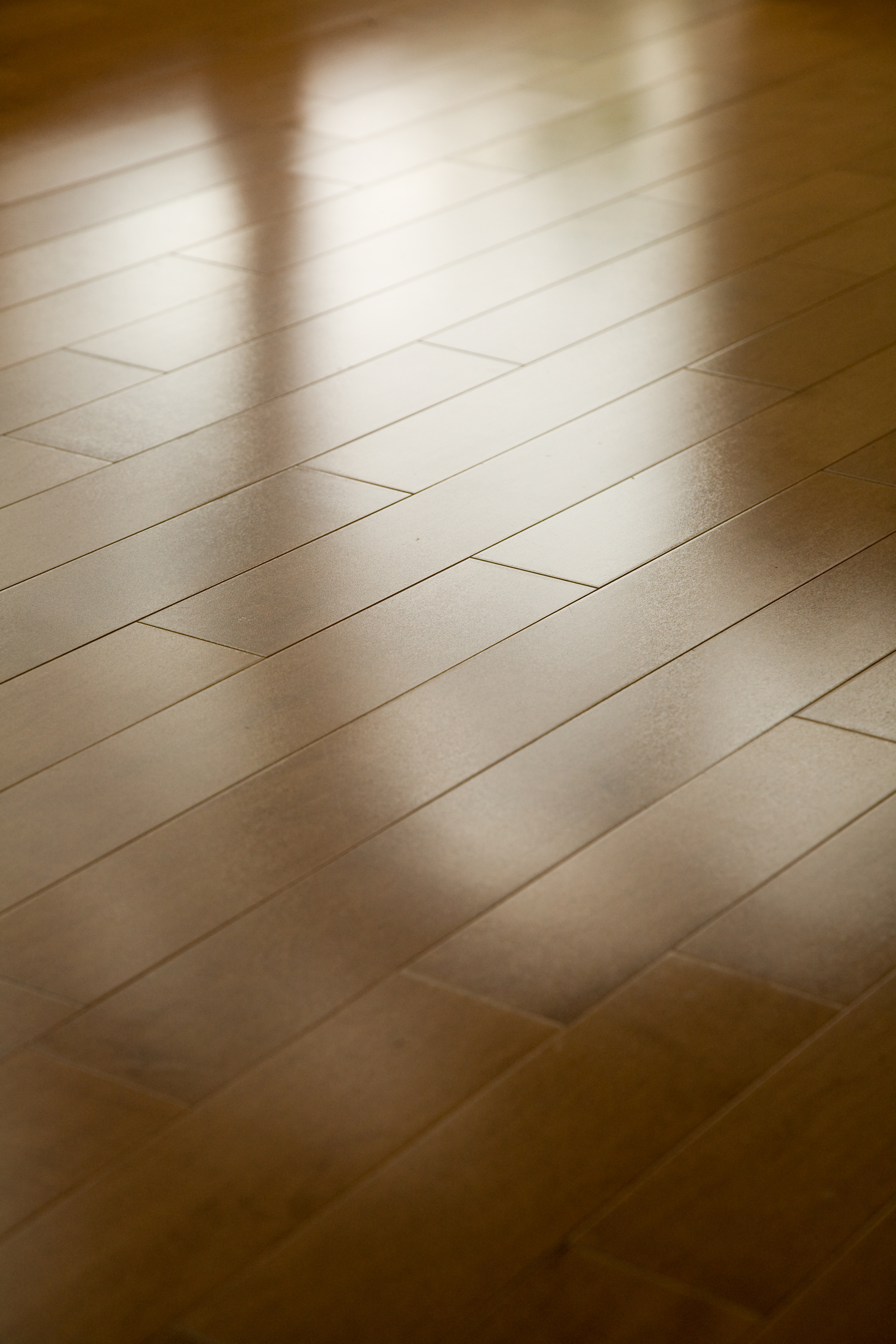 A hardwood floor with a light, natural finish applied by Footprints Floors Omaha professionals.