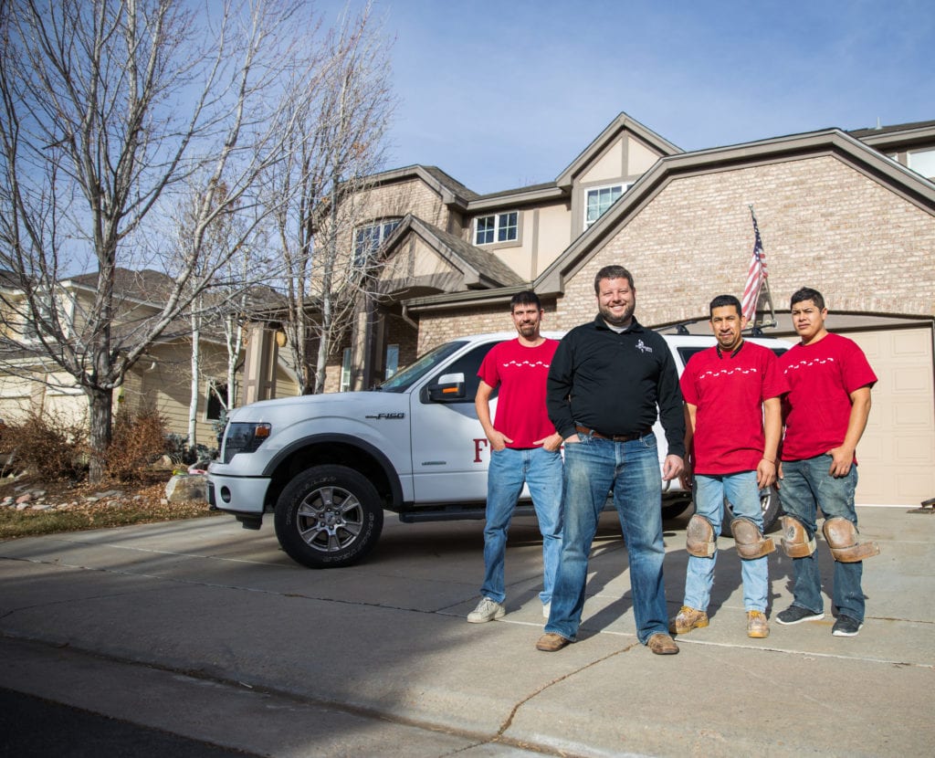 Bryan Park, CEO, standing in front of a branded truck with his contracting team - leave corporate America and join Footprints Floors, one of the best franchises to own.
