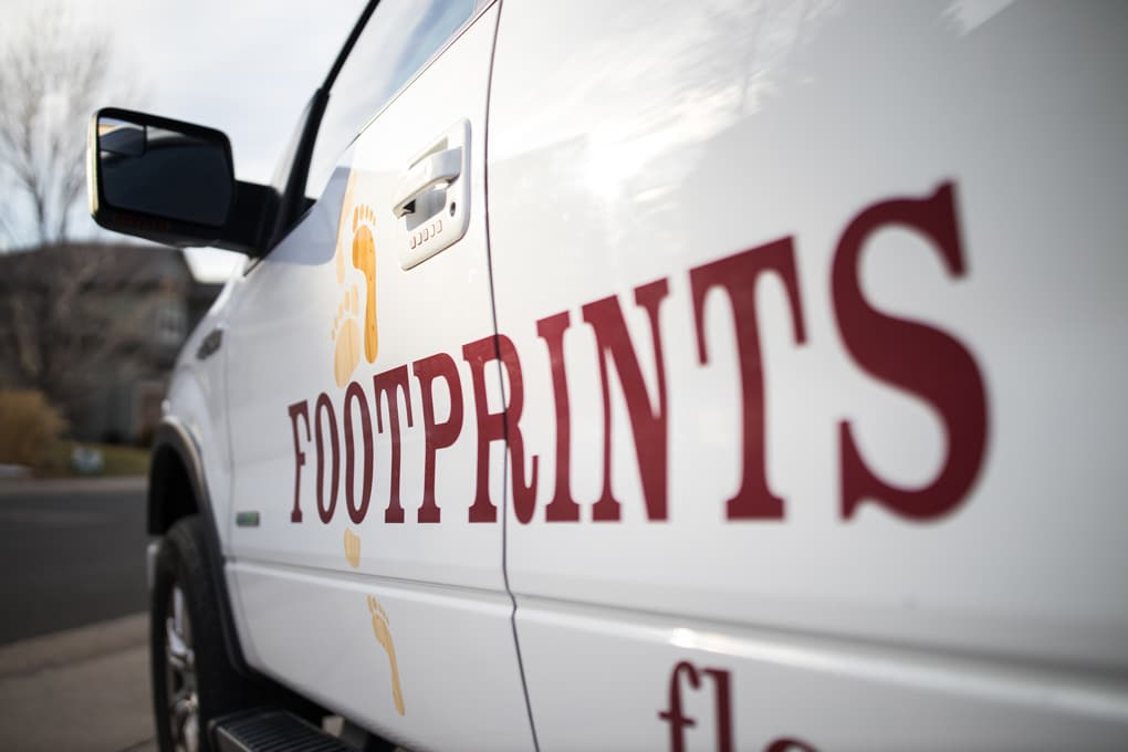 An image of the side of a Footprints Floors service vehicle - work with Footprints Floors today.