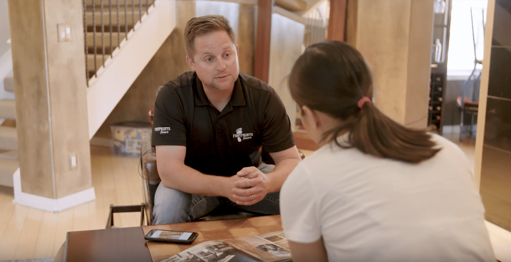 A Footprints Floors team member communicating with a client.