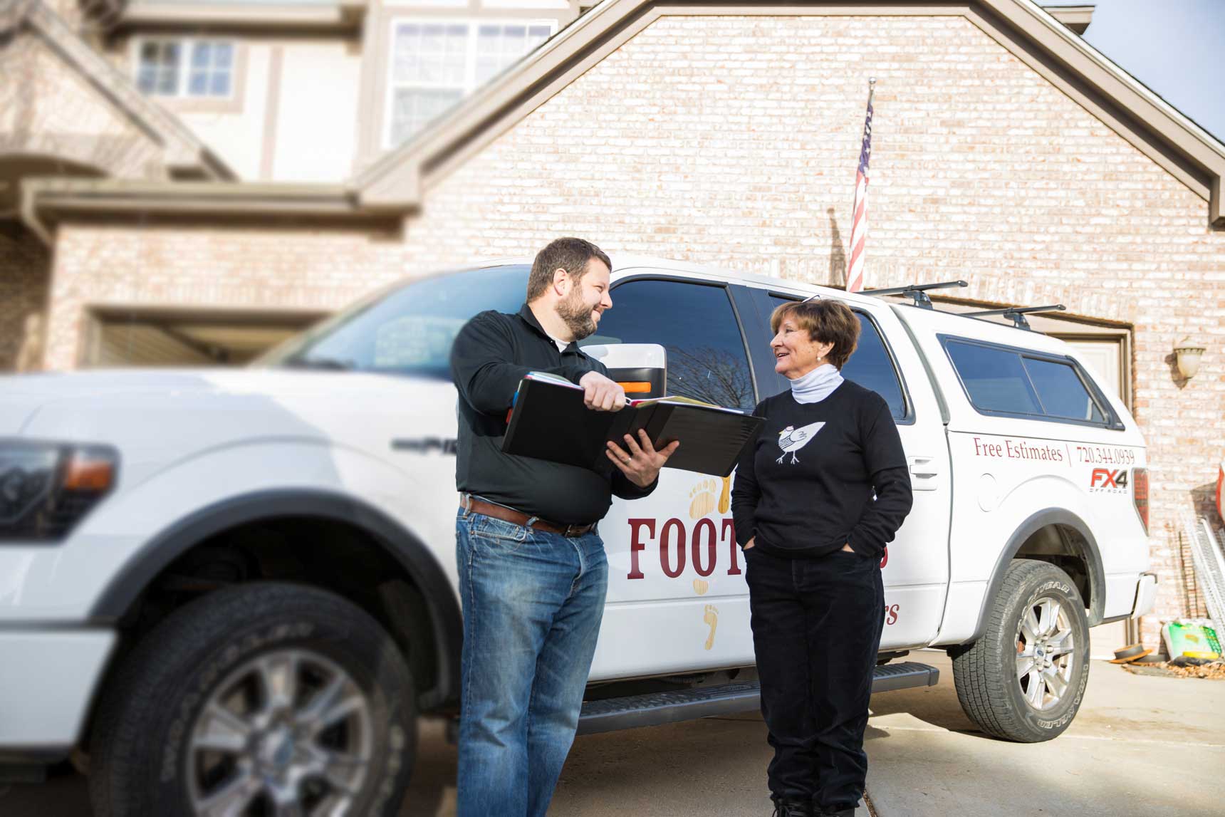 Bryan Park, CEO, standing with a client outside of her home.
