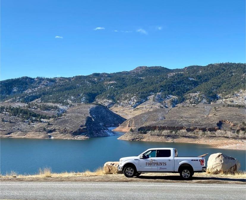 A Footprints Floors branded truck in front of a lake - learn more about starting a flooring business by contacting us today.