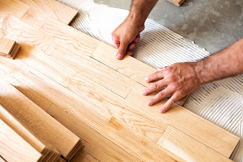 A Footprints Floors employee installing new flooring.
