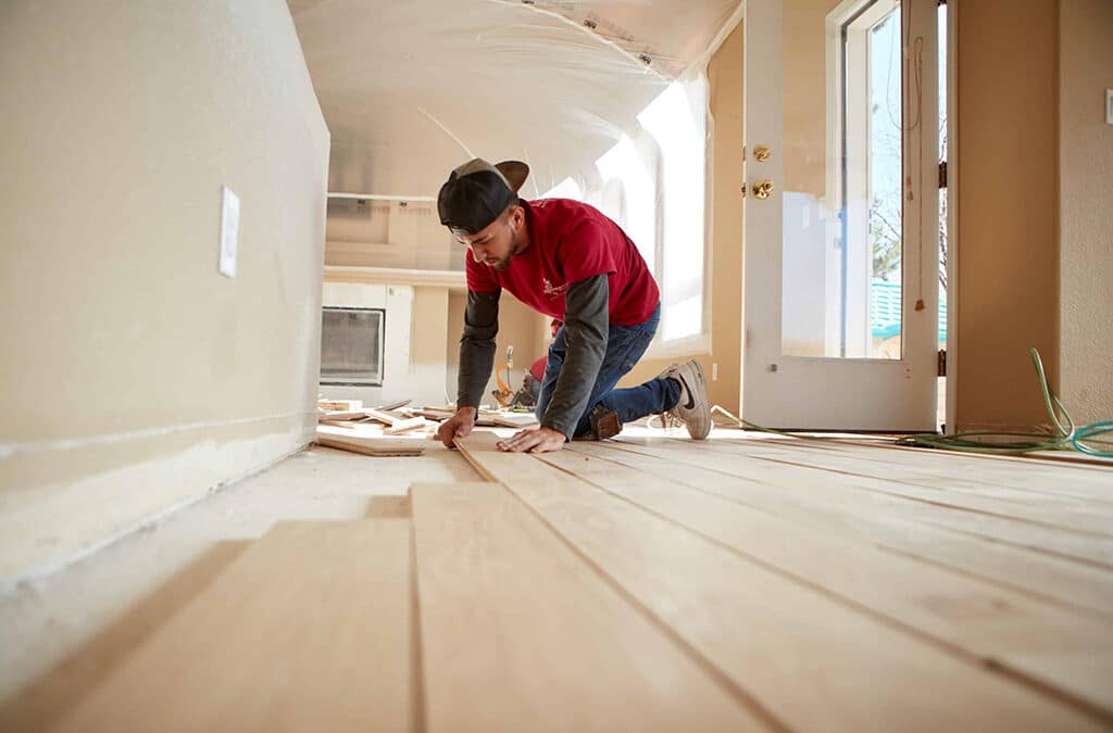 A Footprints Floors team member working on sinstalling hardwood floors.