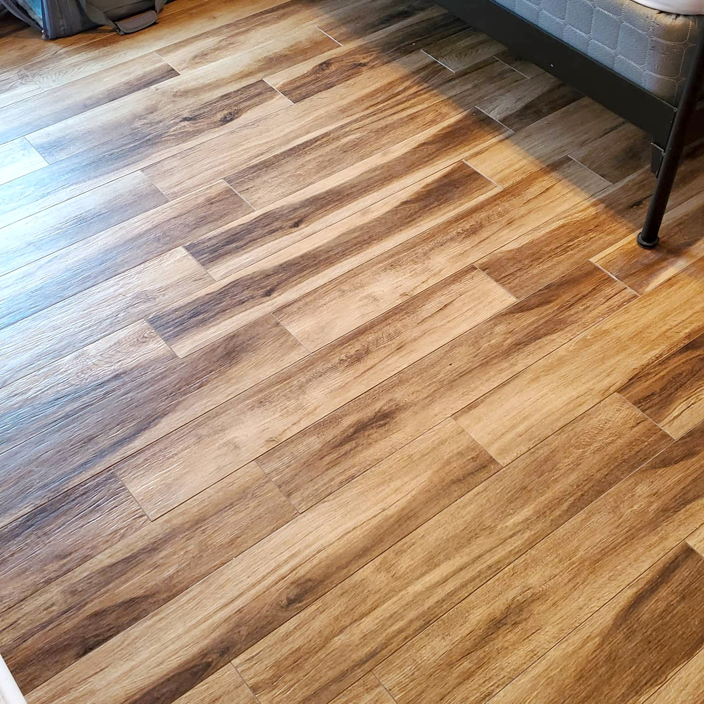 Wood-look tiles in a bathroom - Footprints Floors in Tampa has experts at installing!