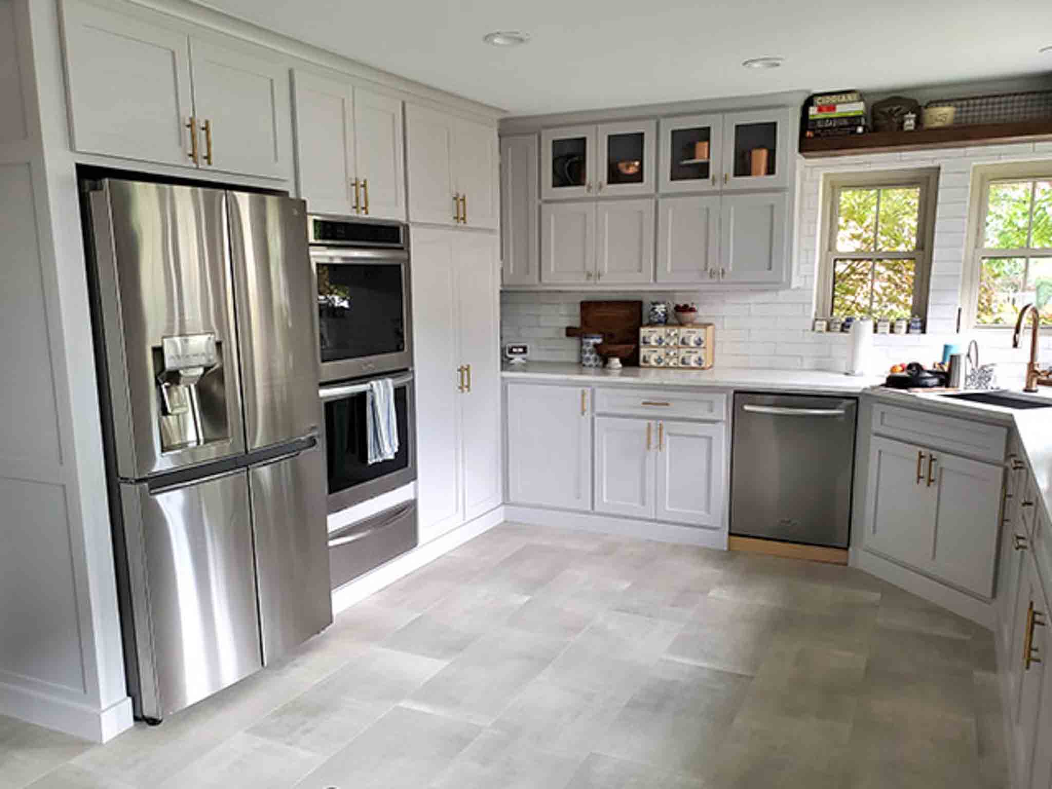 Grey tile flooring and glass backsplash installed by Footprints Floors South Sacramento.