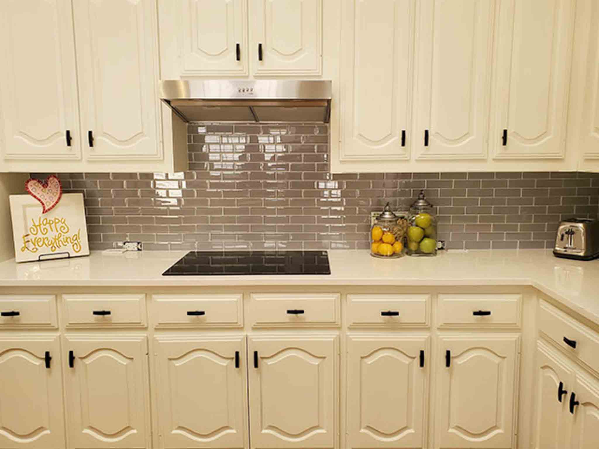Grey tile flooring and glass backsplash installed by Footprints Floors South Sacramento.