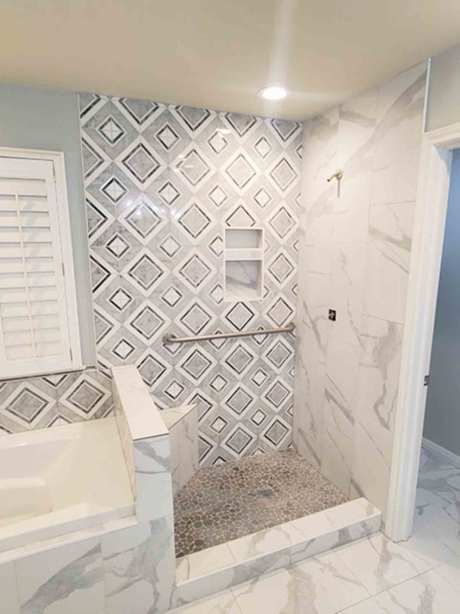A white tile bathroom with a stand up shower, done by Footprints Floors South Sacramento.