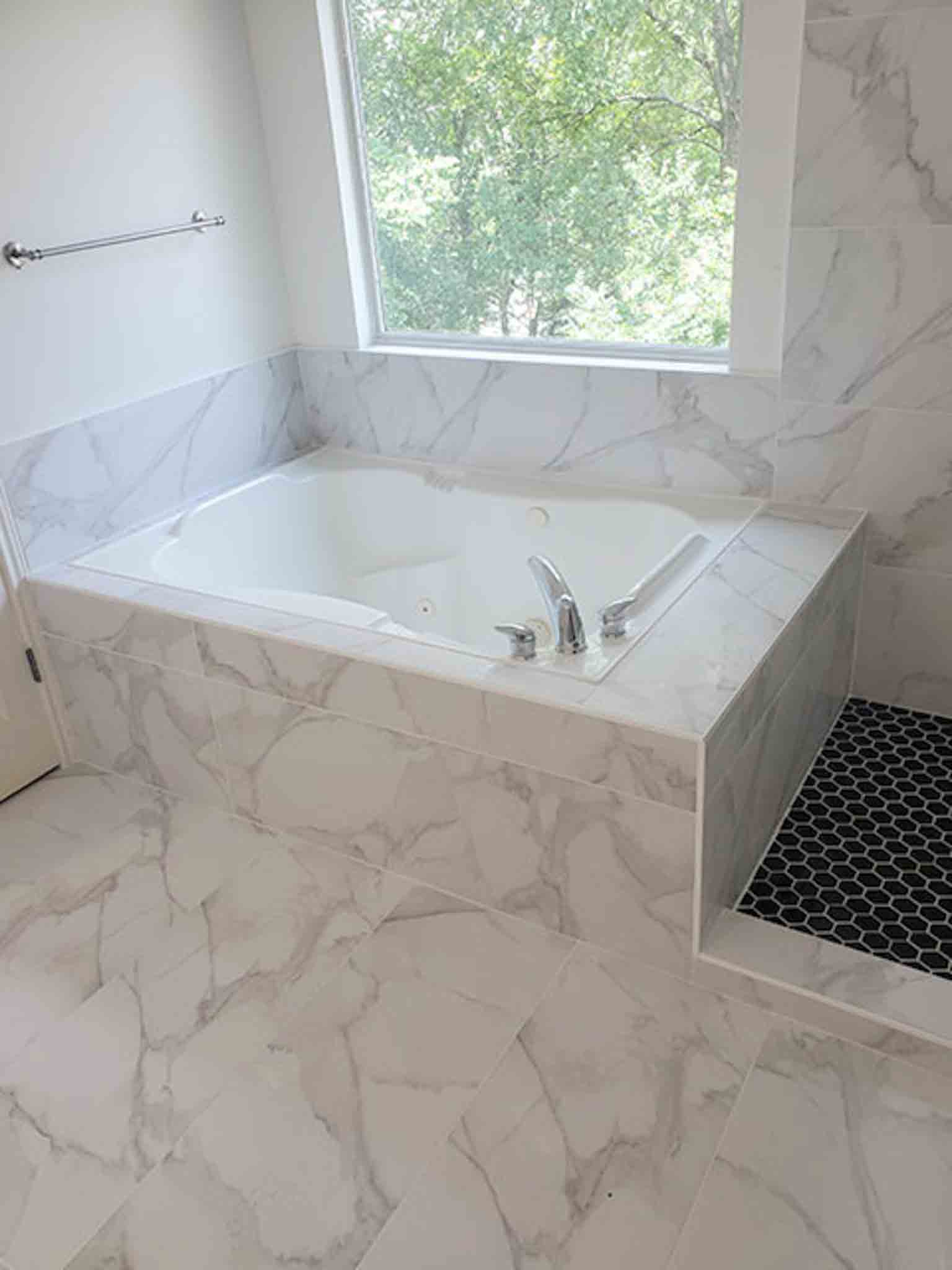 A white tiles bathtub, installed by Footprints Floors South Sacramento.