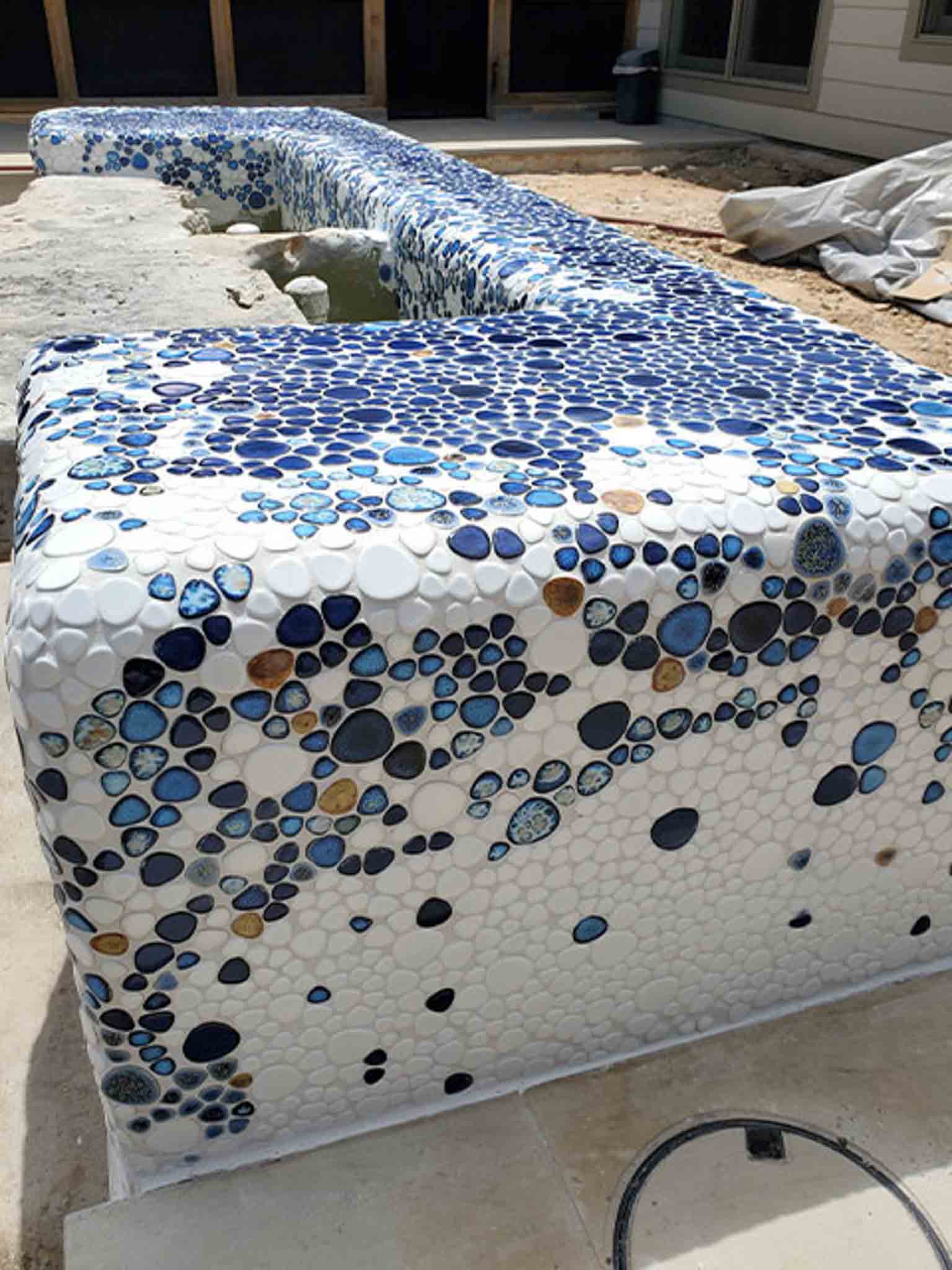 An outdoor fountain with blue tile, done by Footprints Floors South Sacramento.