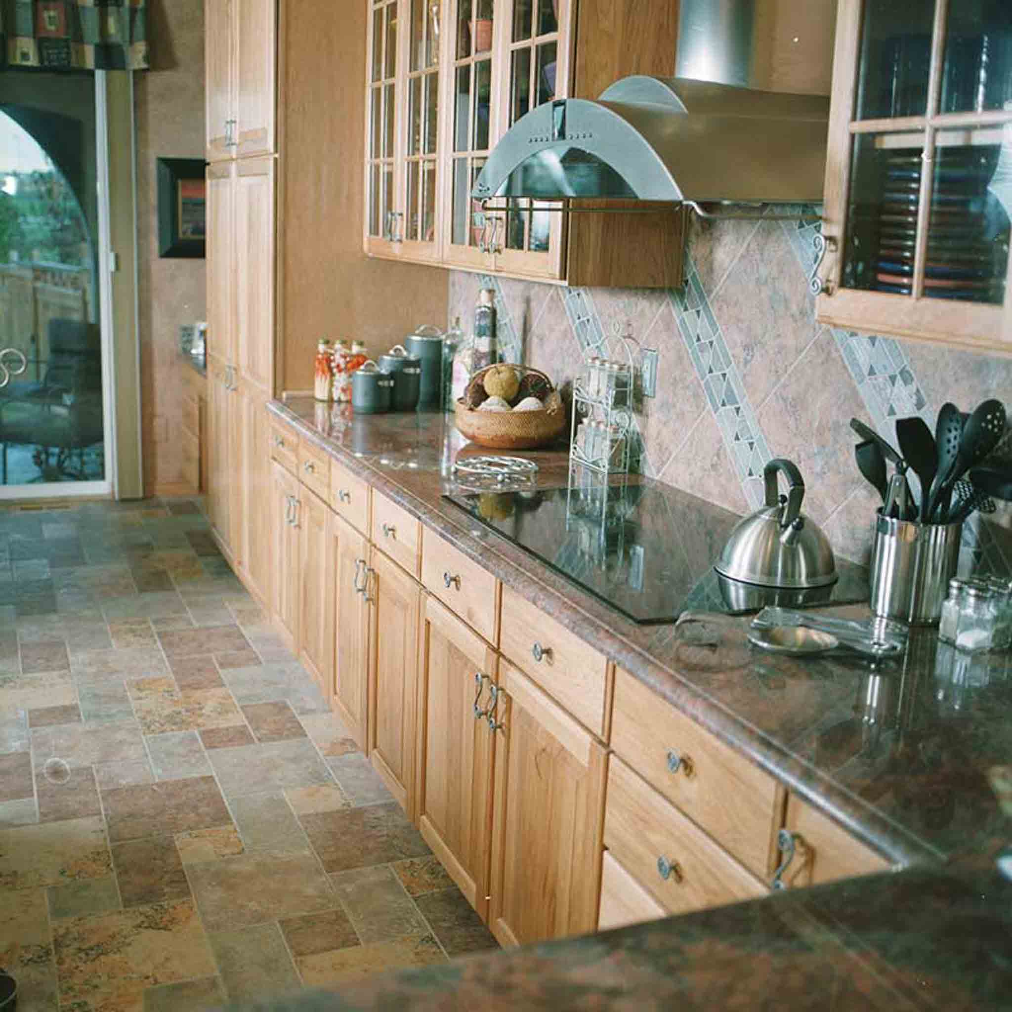 A kitchen with tile flooring and backsplash, installed by Footprints Floors South Sacramento.