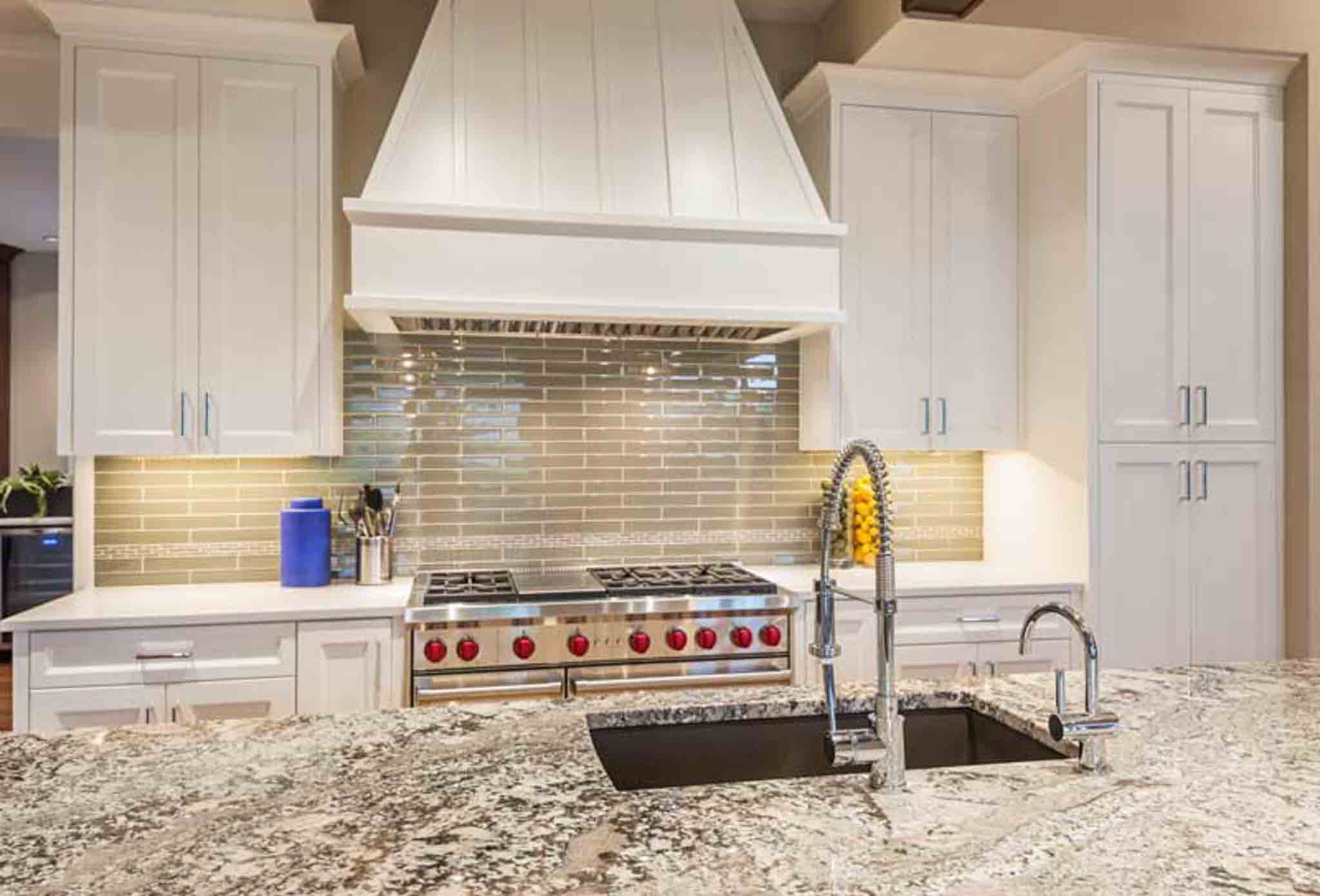 A grey backsplash installed in a kitchen.