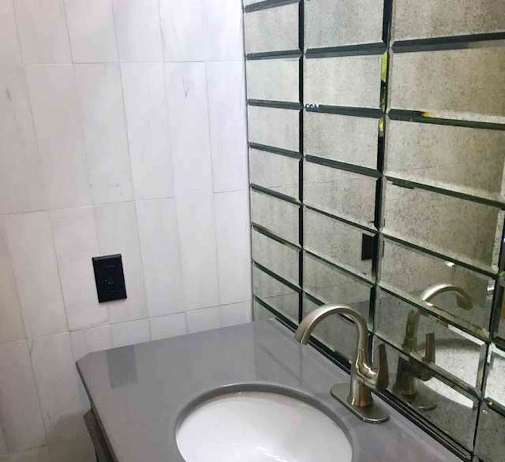 A glass backsplash in a bathroom.