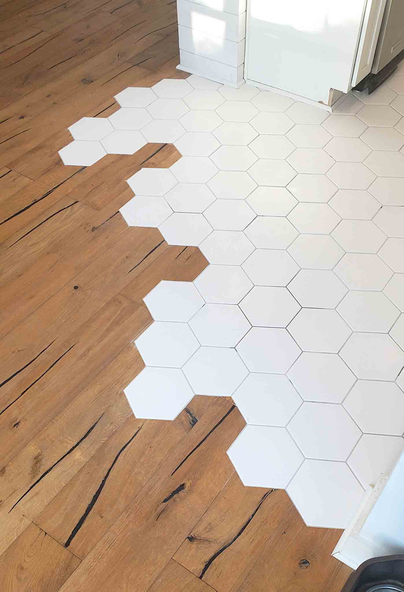 White hexagon tiles and wood flooring, installed by Footprints Floors South Sacramento.