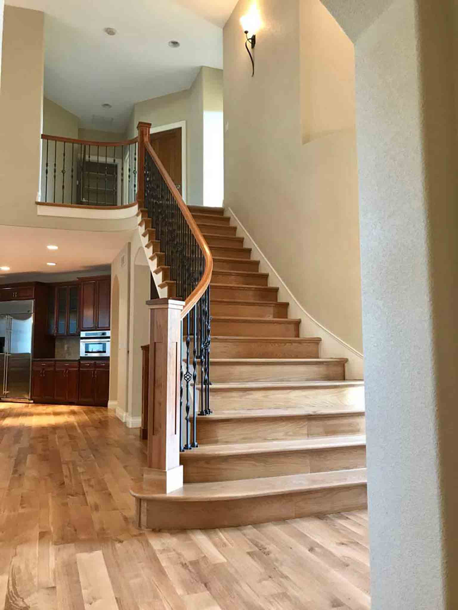 A staircase with light brown wood, installed by Footprints Floors South Sacramento.