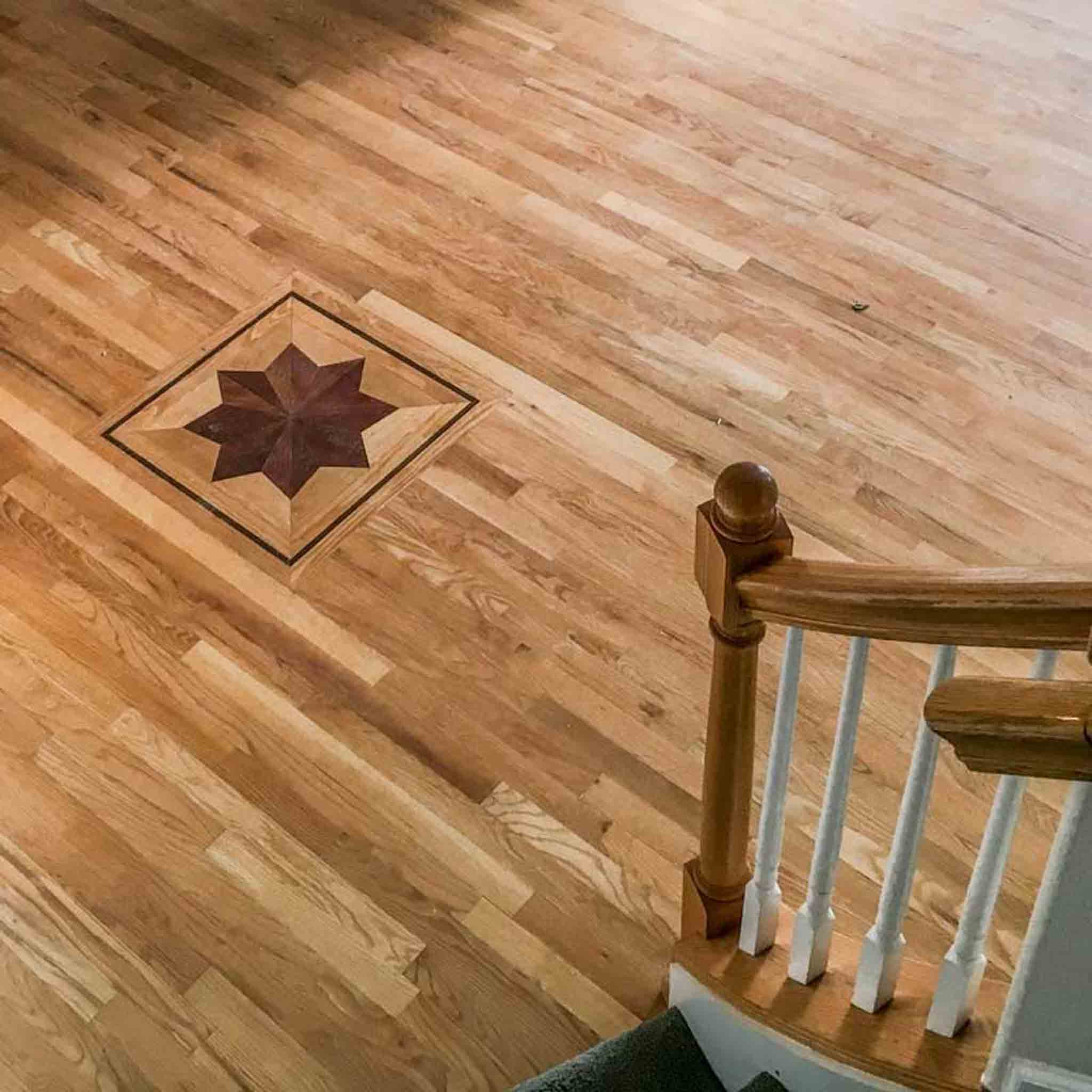 A wood floor with a star design, done by Footprints Floors South Sacramento.