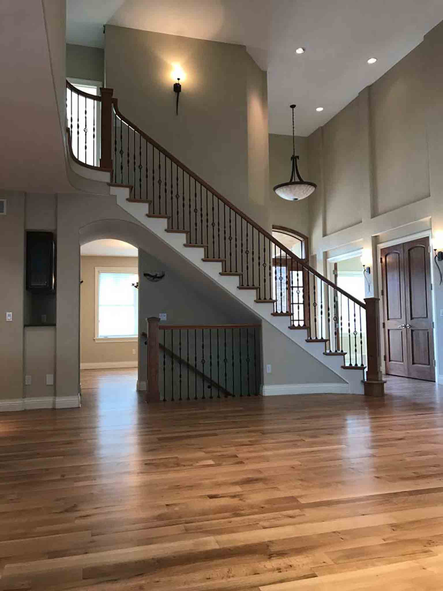 A large staircase with wood flooring.