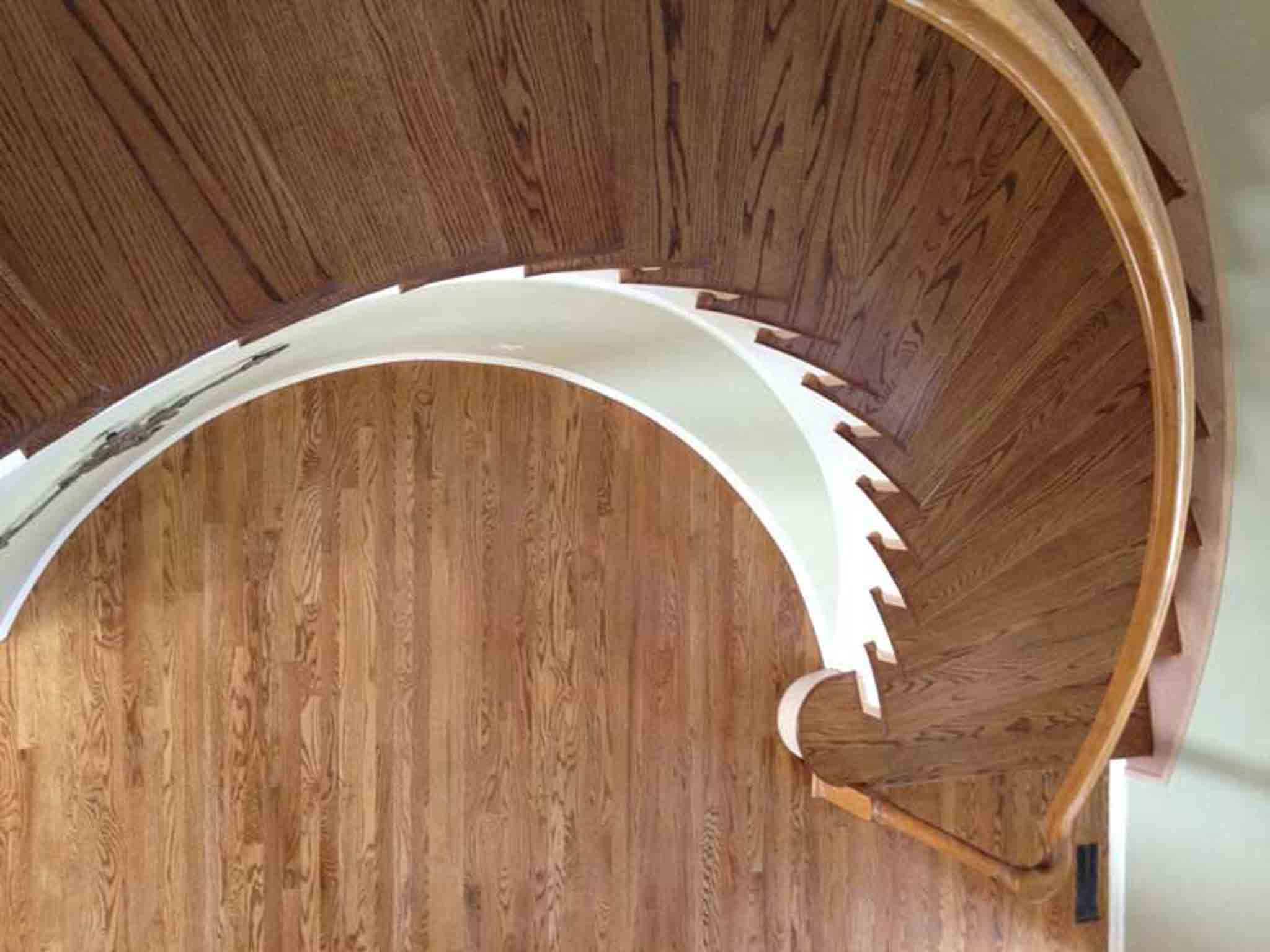 Large staircase with light wood flooring.
