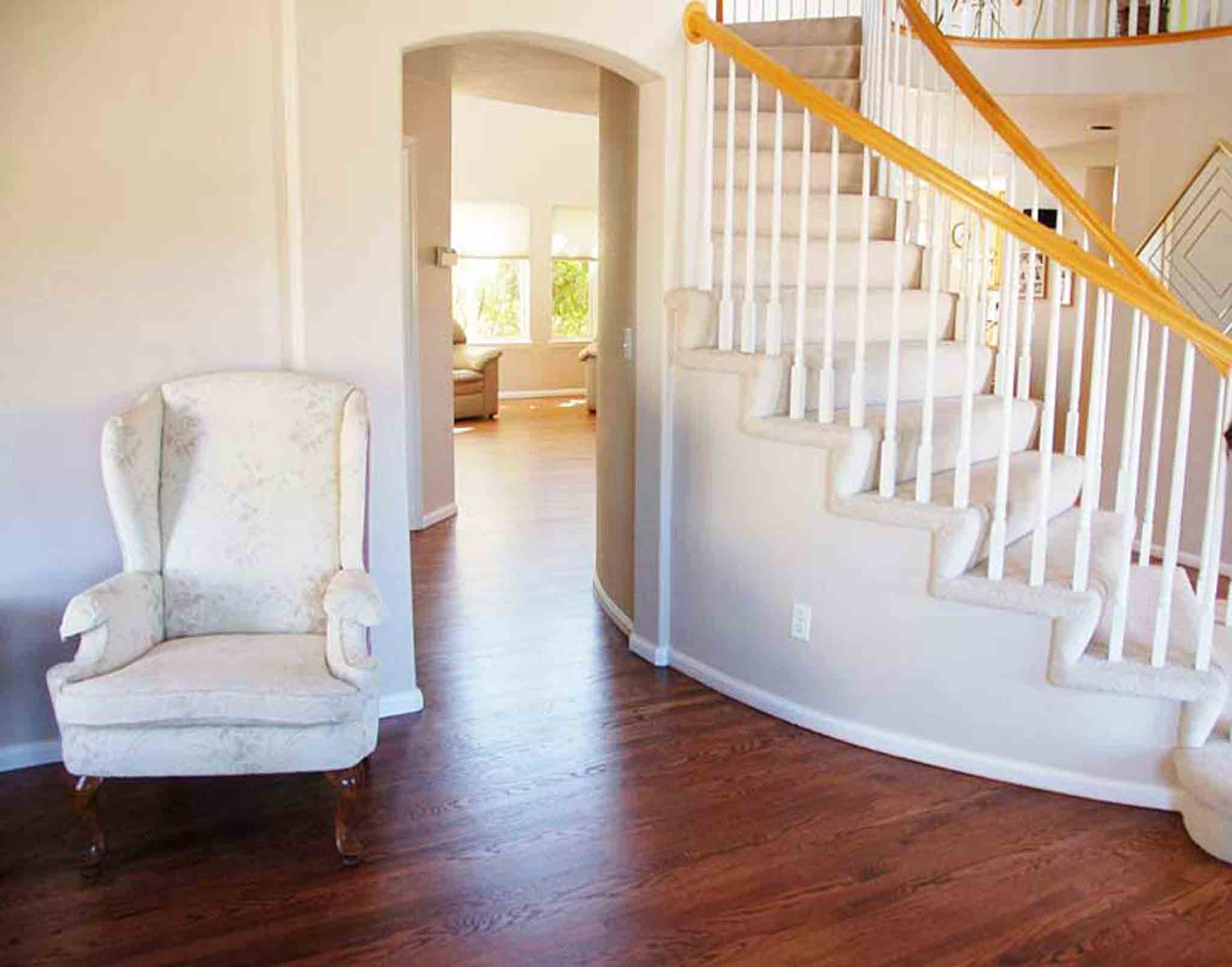 Dark brown wood flooring surrounding a staircase with carpet, installed by Footprints Floors South Sacramento.