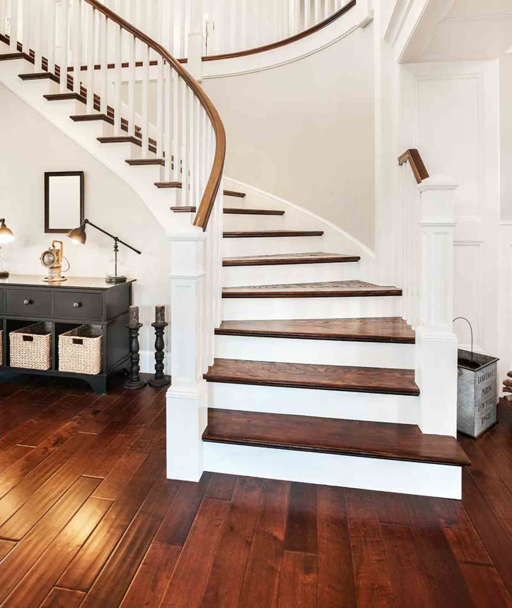 Dark walnut wood installed on a white staircase and floor.