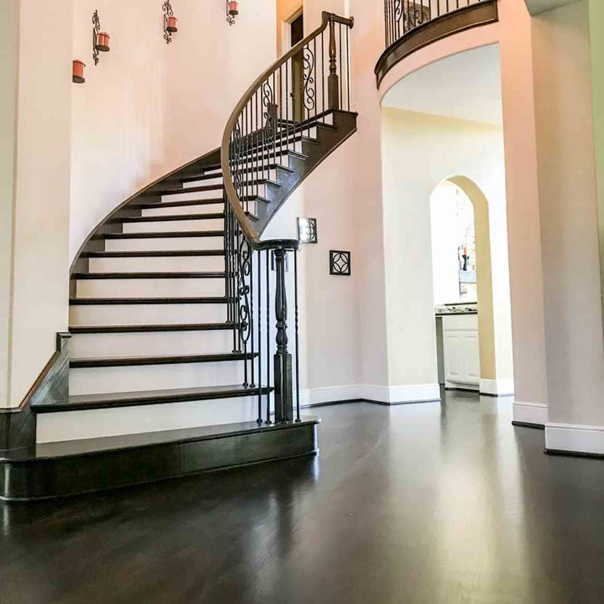 A staircase with black laminate / lvp flooring.