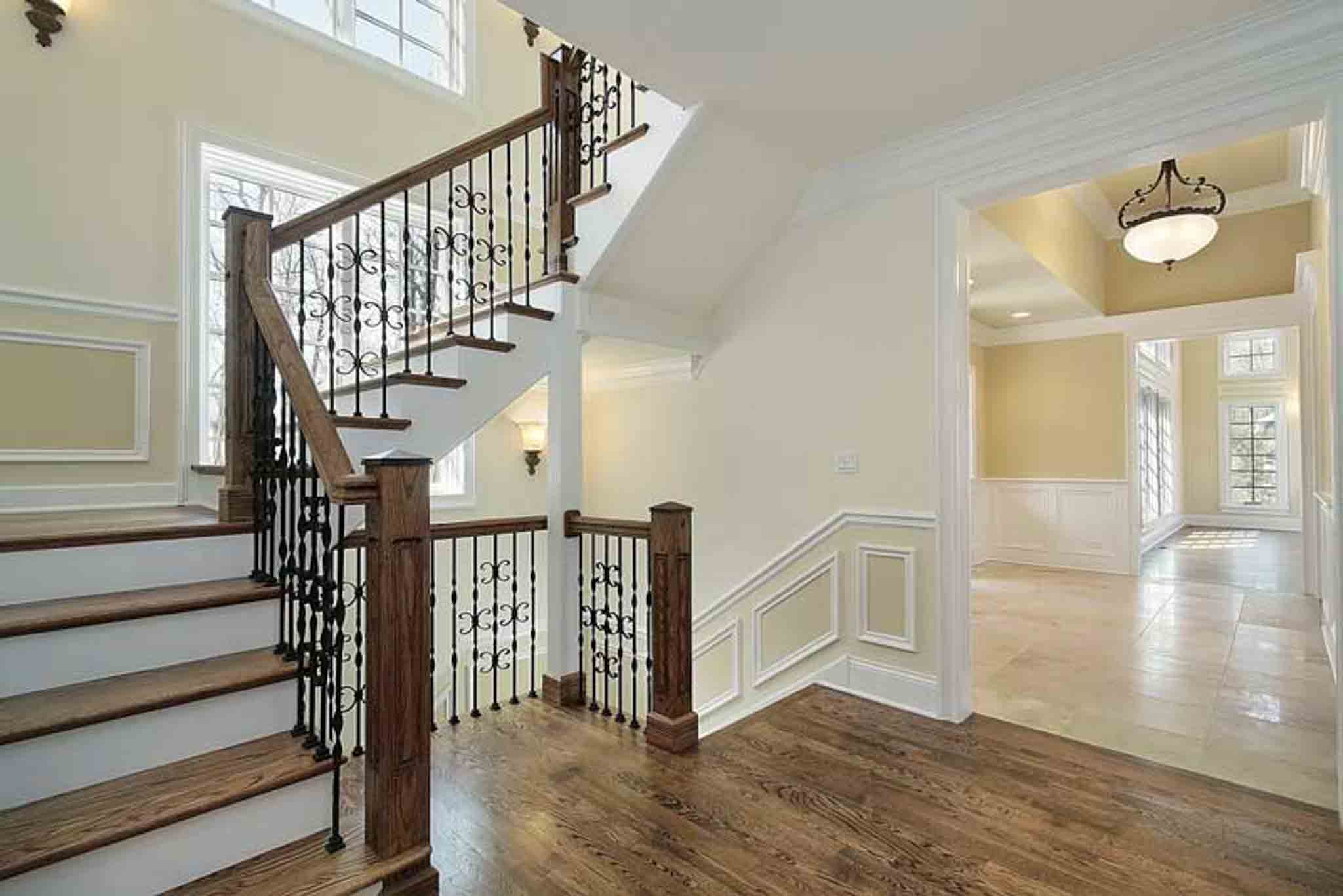 A large staircase with dark wood flooring.