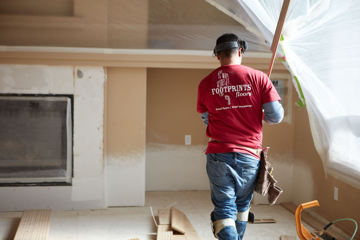 A Footprints Floors technician installing new hardwood floor - contact us today to learn more about investing in one of the top flooring franchises for sale!