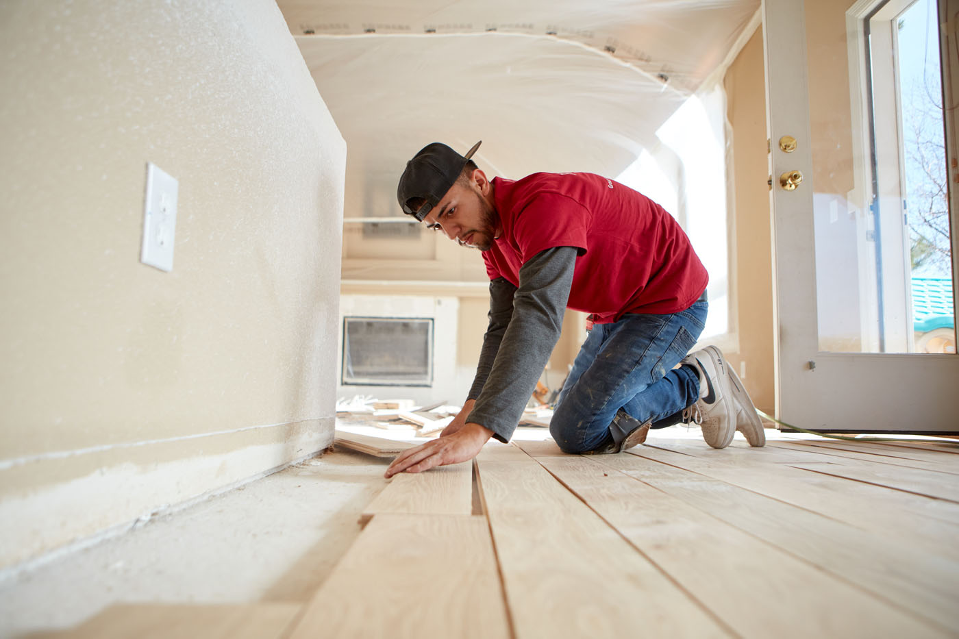 A Footprints Floors technician installing new hardwood flooring.