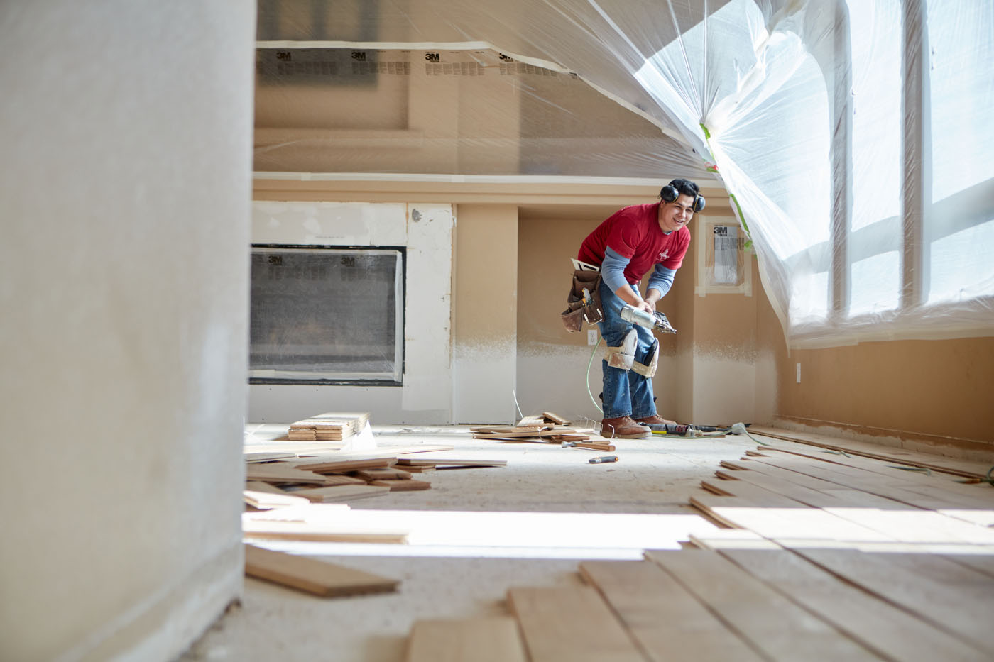 A Footprints Floors technician installing top-quality hardwood flooring.