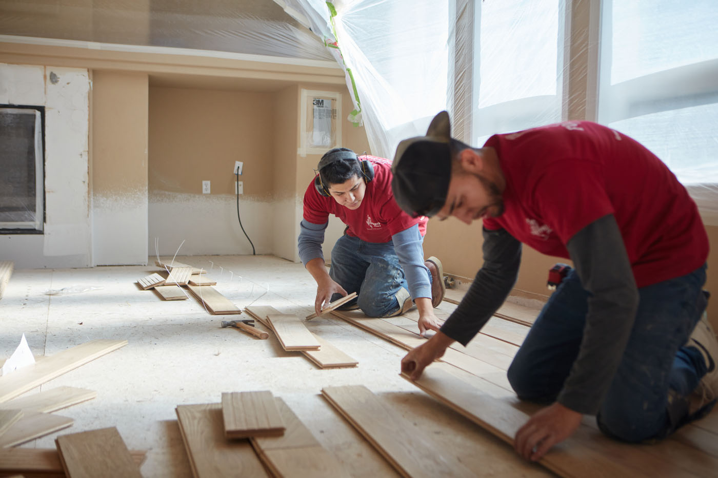 Two Footprints Floors professionals installing new floors in a home - trust us to be your go-to flooring company in Sacramento, CA.