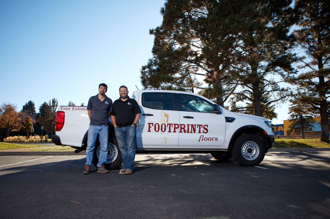 An image of Bryan Park next to one of our service vehicles - explore Footprints Floors franchise opportunities and join a fast-growing flooring company.