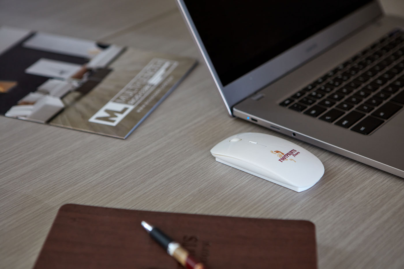 An image of Footprints Floors work computers, note pads, and more.