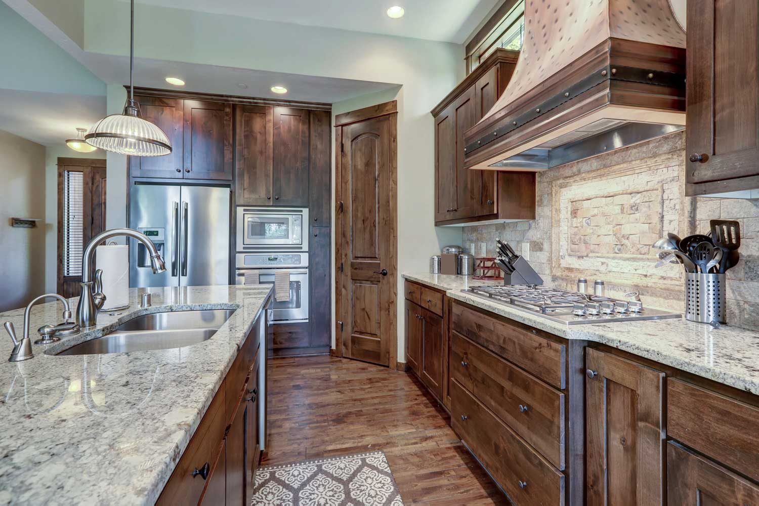 Beautiful stone bathroom backsplash installation in Chandler / Gilbert with Footprints Floors.