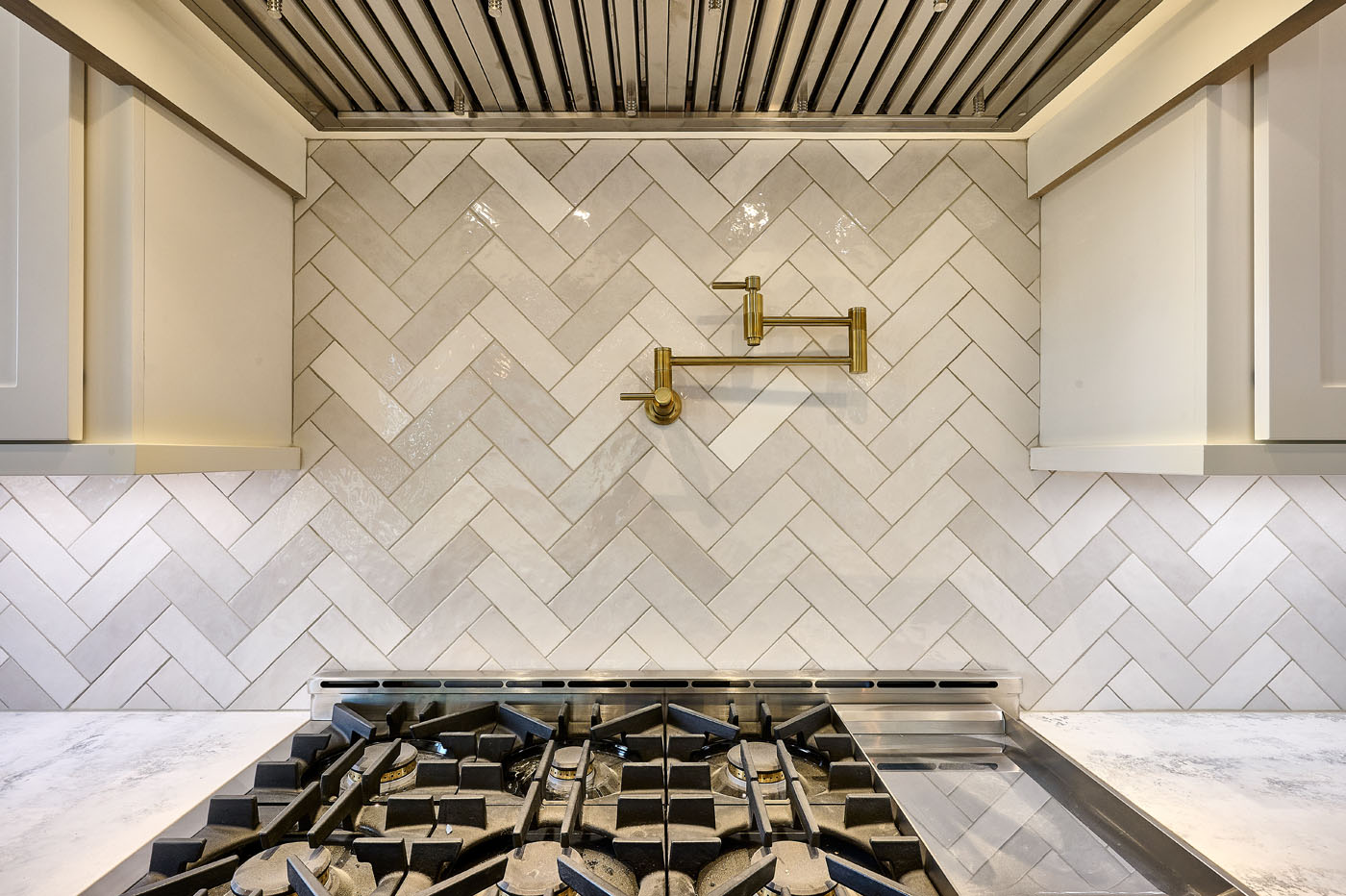 A finished tiled kitchen backsplash with a herringbone design from the expert installers at Footprints Floors South Sacramento.