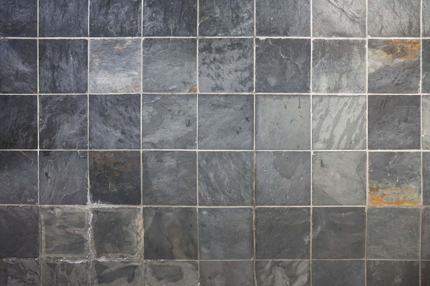 A close up of a stone tile backsplash.