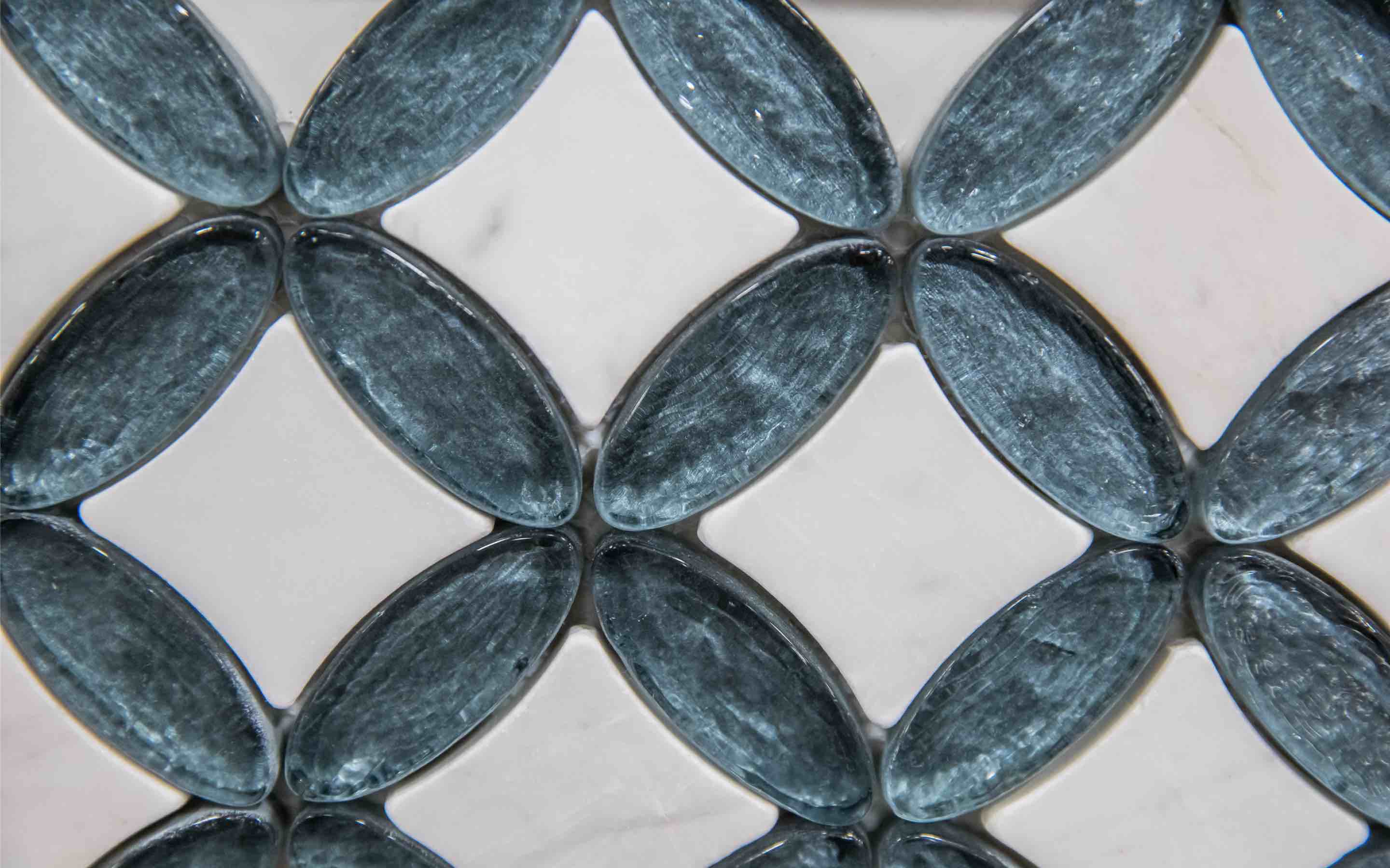 A close-up of a bathroom tiled backsplash with a stylish, unique design.