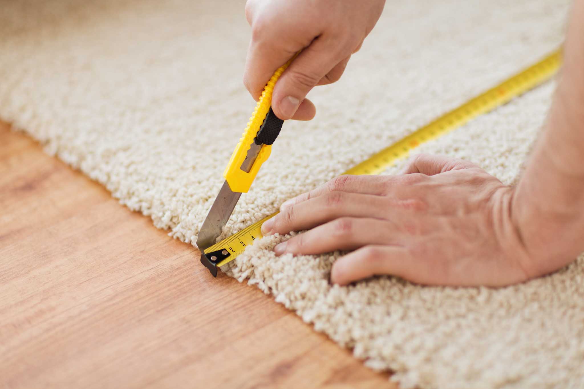 A professional installing carpet - hire Footprints Floors for flooring and carpet installation in Sacramento, CA today.