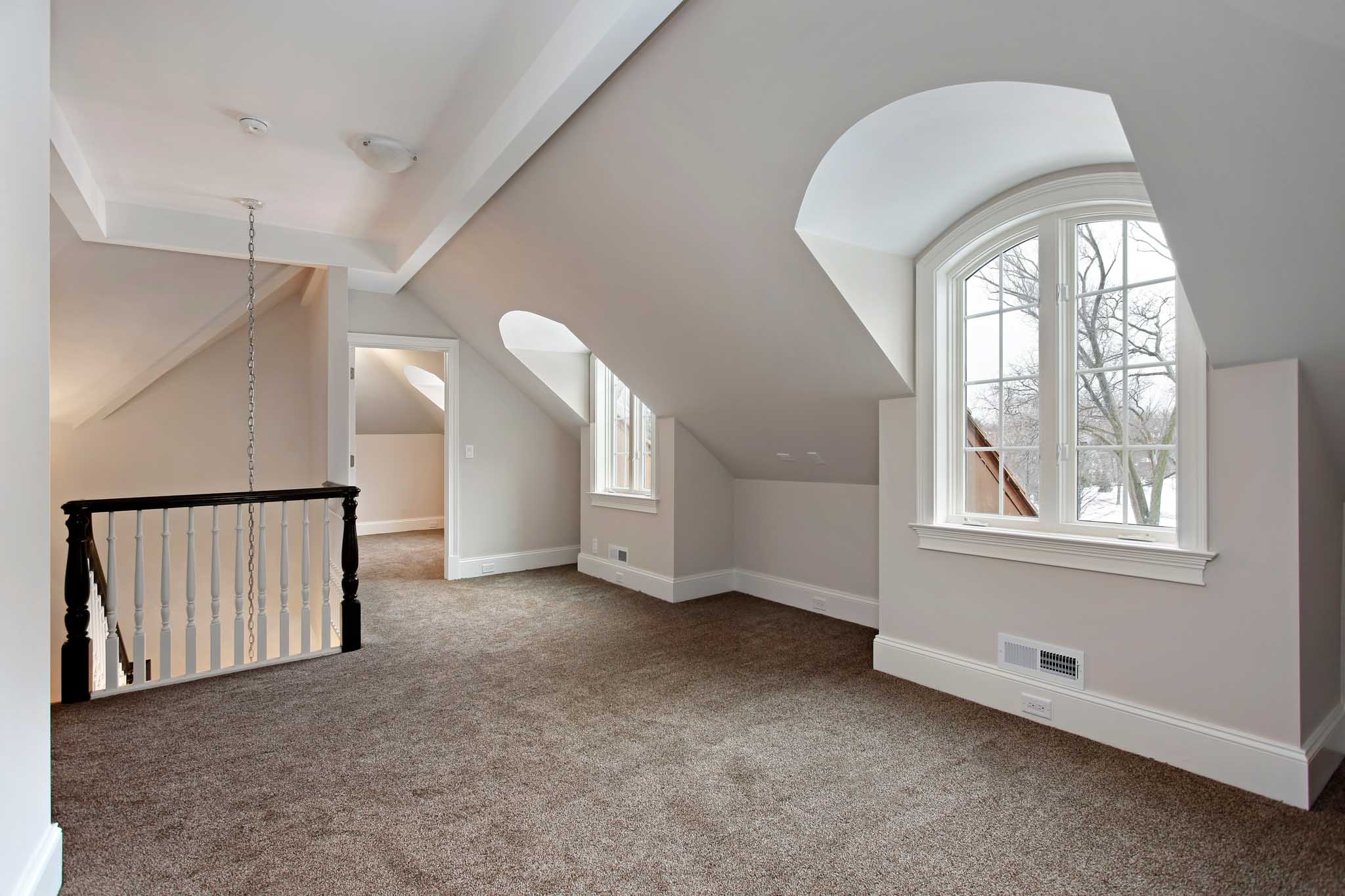 A beautiful upstairs area covered in carpet.
