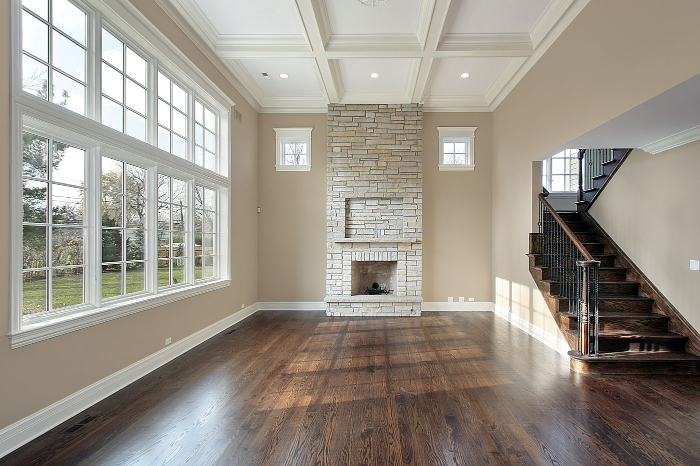 An empty, bright room with sleek hardwood floors.