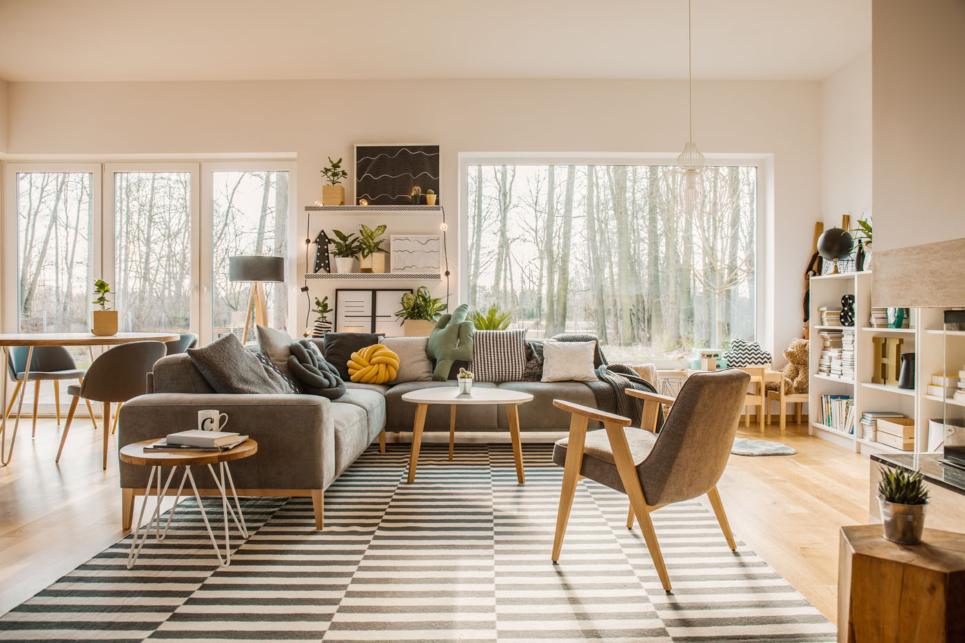 A beautiful modern home with rugs and hardwood floors - find flooring inspiration with these blogs from Footprints Floors.
