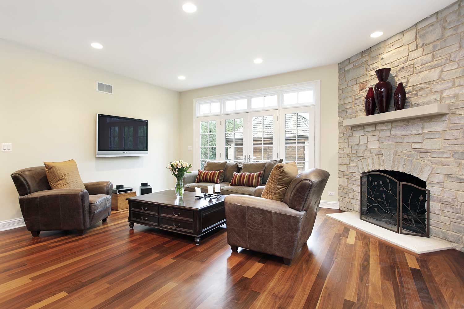 Beautiful walnut flooring in a living room, contact Footprints Floors today for a free estimate.