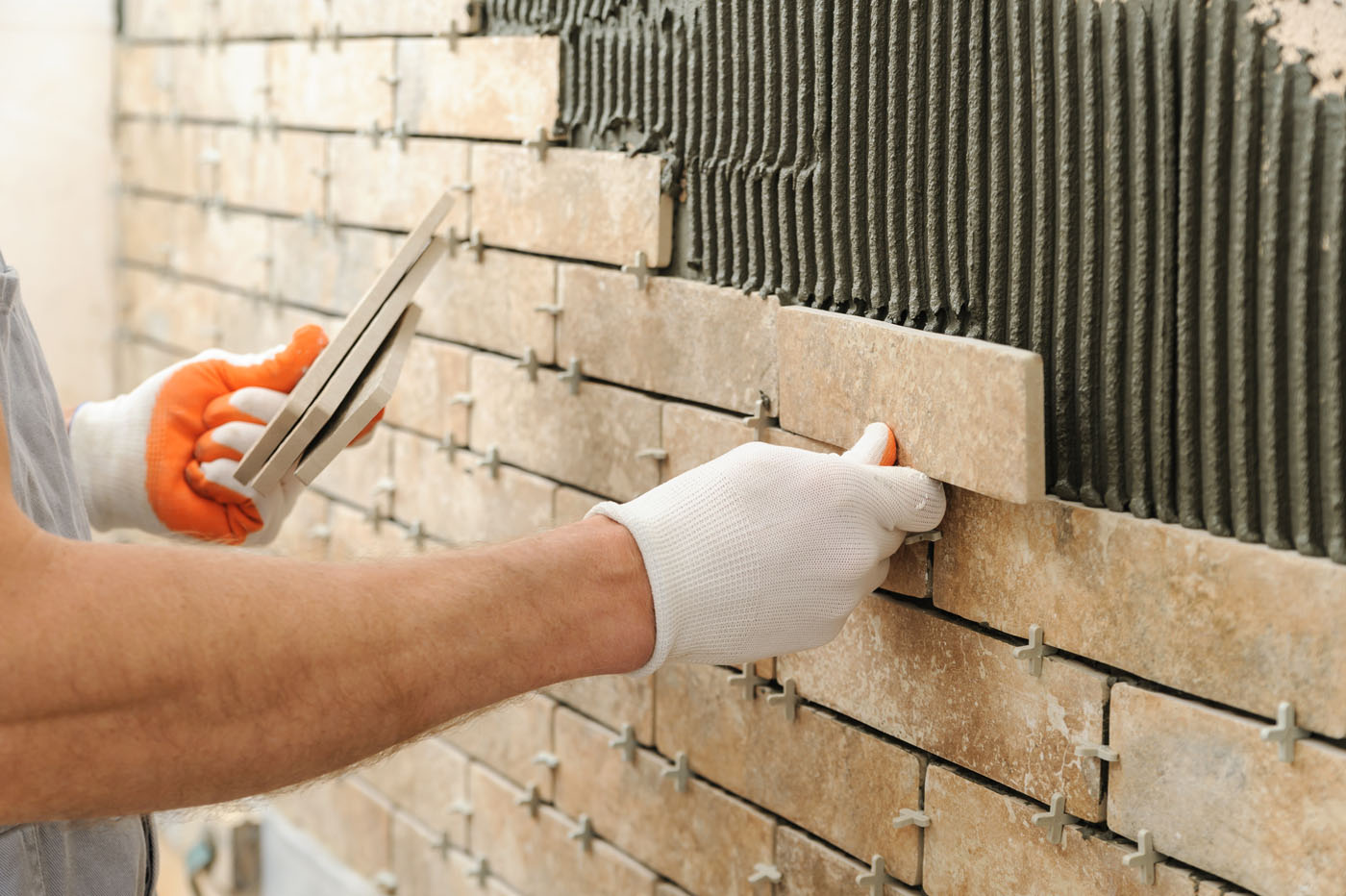 A San José bathroom backsplash installation in progress with an expert from Footprints Floors.