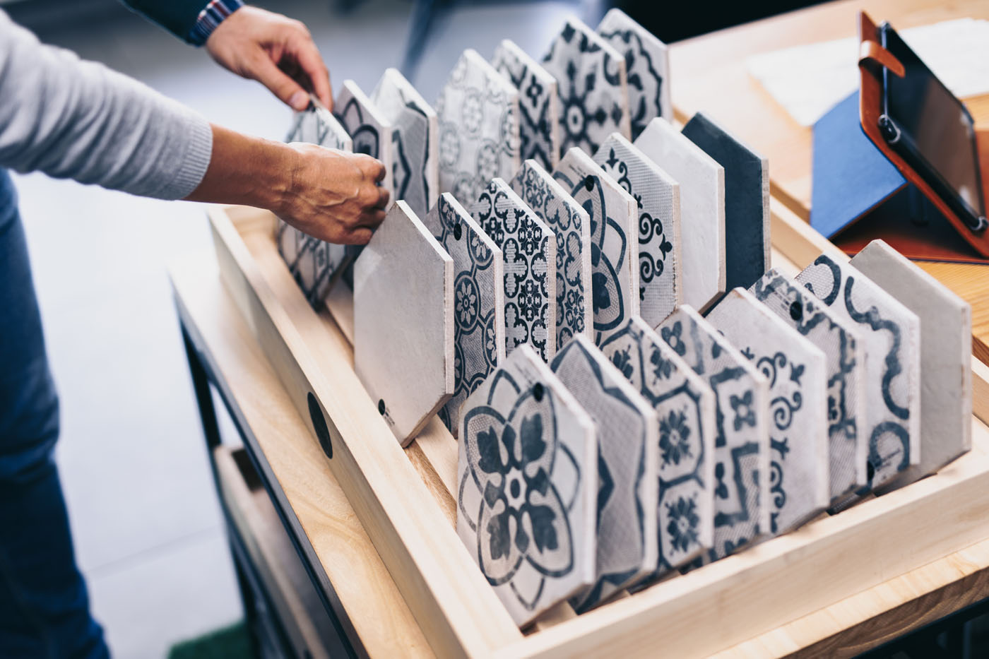 A homeowner choosing the perfect tile material for the backsplash installation with Footprints Floors.