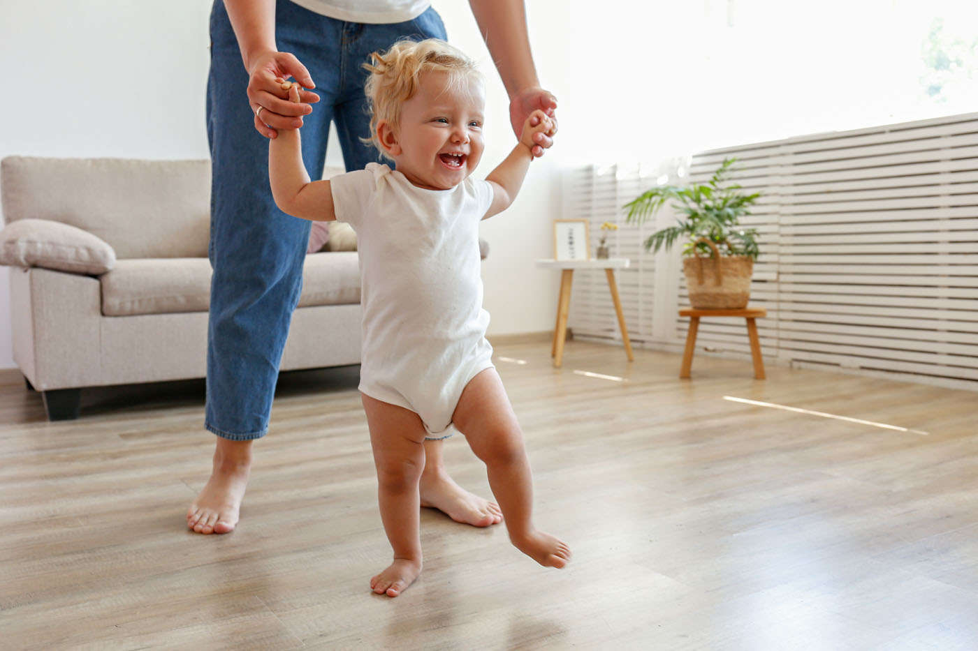 A picture of a parent and a baby playing on the vinyl flooring - Footprints Floors in Sacramento, CA.