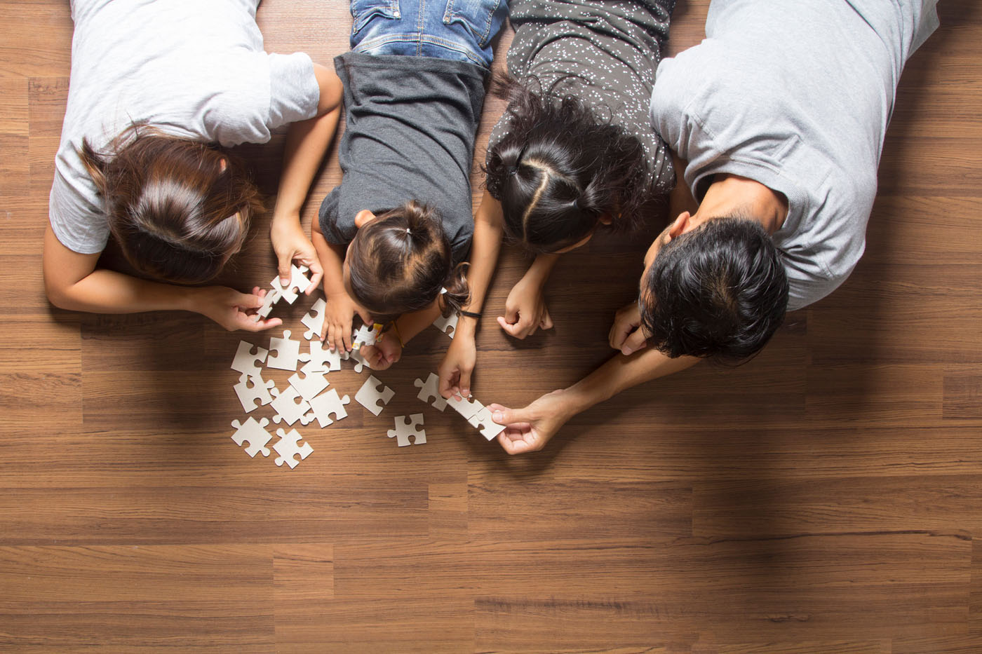 A family playing on clean vinyl flooring installed by Footprints Floors in San José, CA.