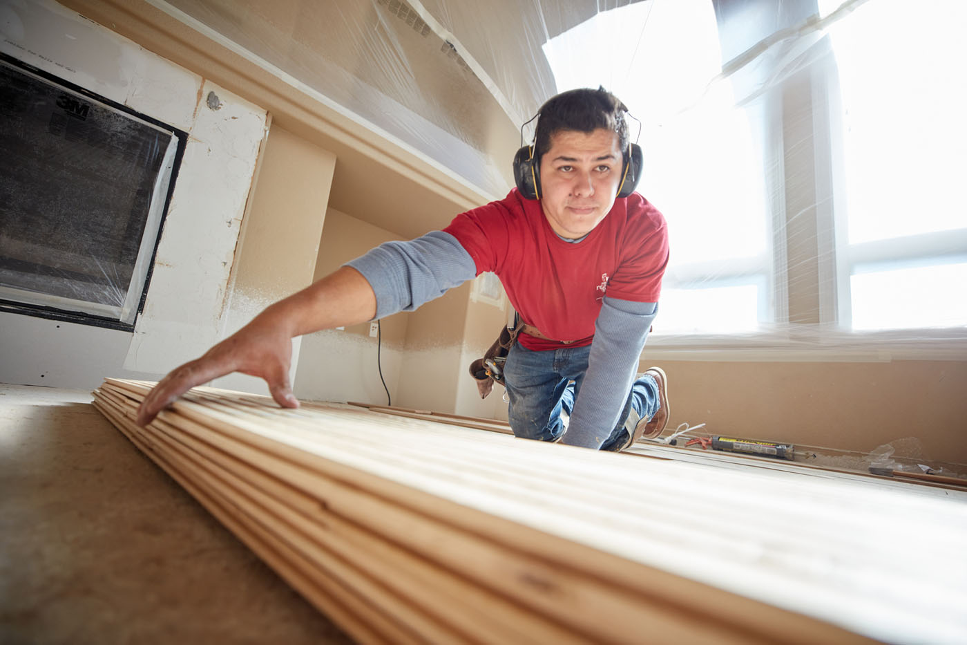 A Footprints Floors South Sacramento team member laying down revel woods products for new flooring in Sacramento, CA.