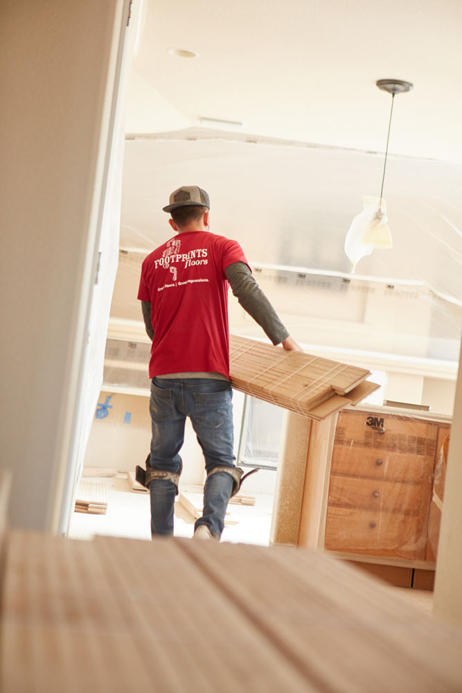 A Footprints Floors South Sacramento worker installing flooring in Sacramento, CA.