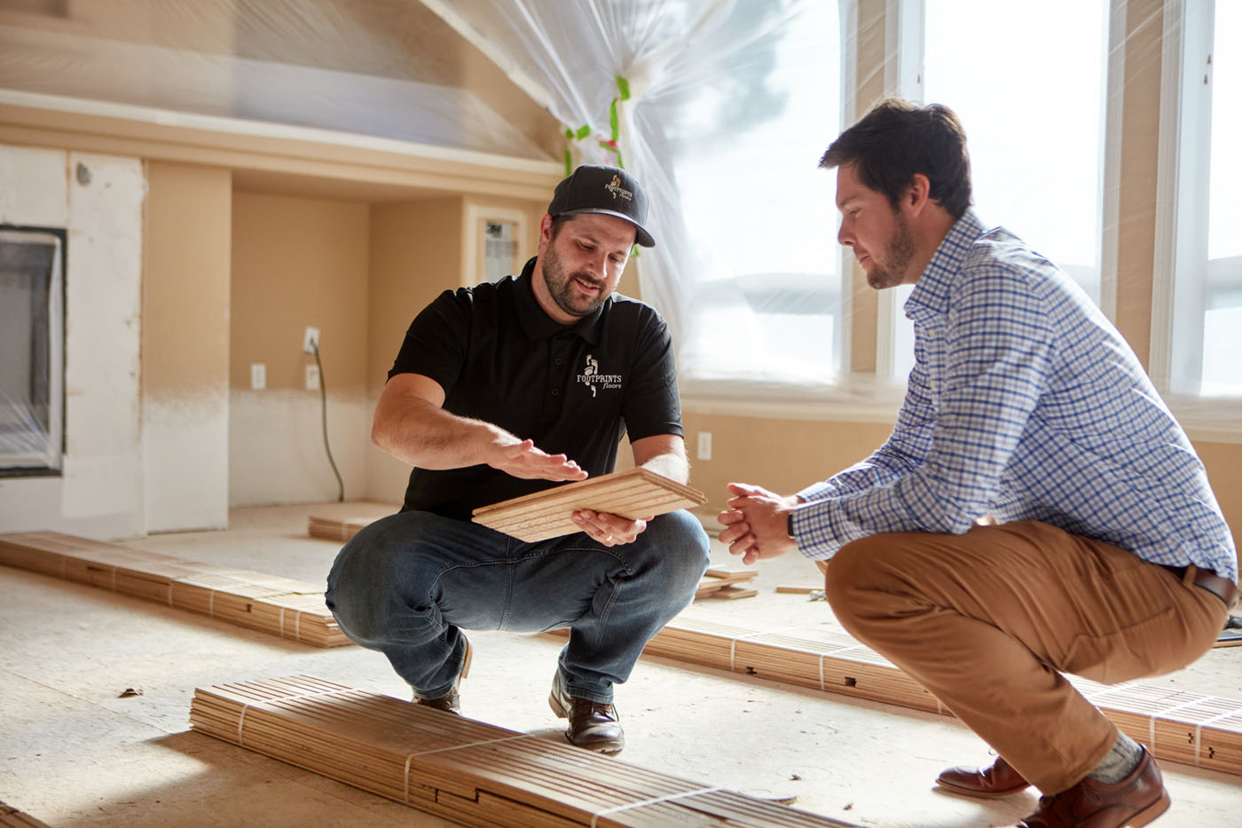 A Footprints Floors contractor going over flooring options with a client - for trusted LVP installers in Woodstock, GA, contact Footprints Floors.