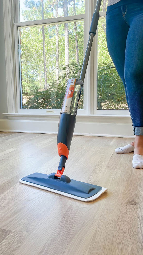 A Footprints Floors expert cleaning tile with Loba products.